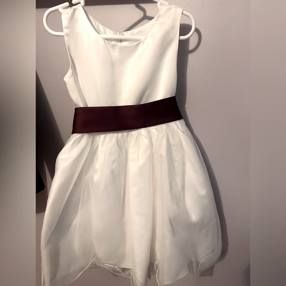 White flower girl dress. Removable dark red / maroon looking bow.